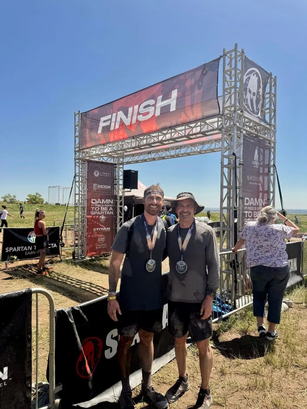 At a Spartan race finish line with friends